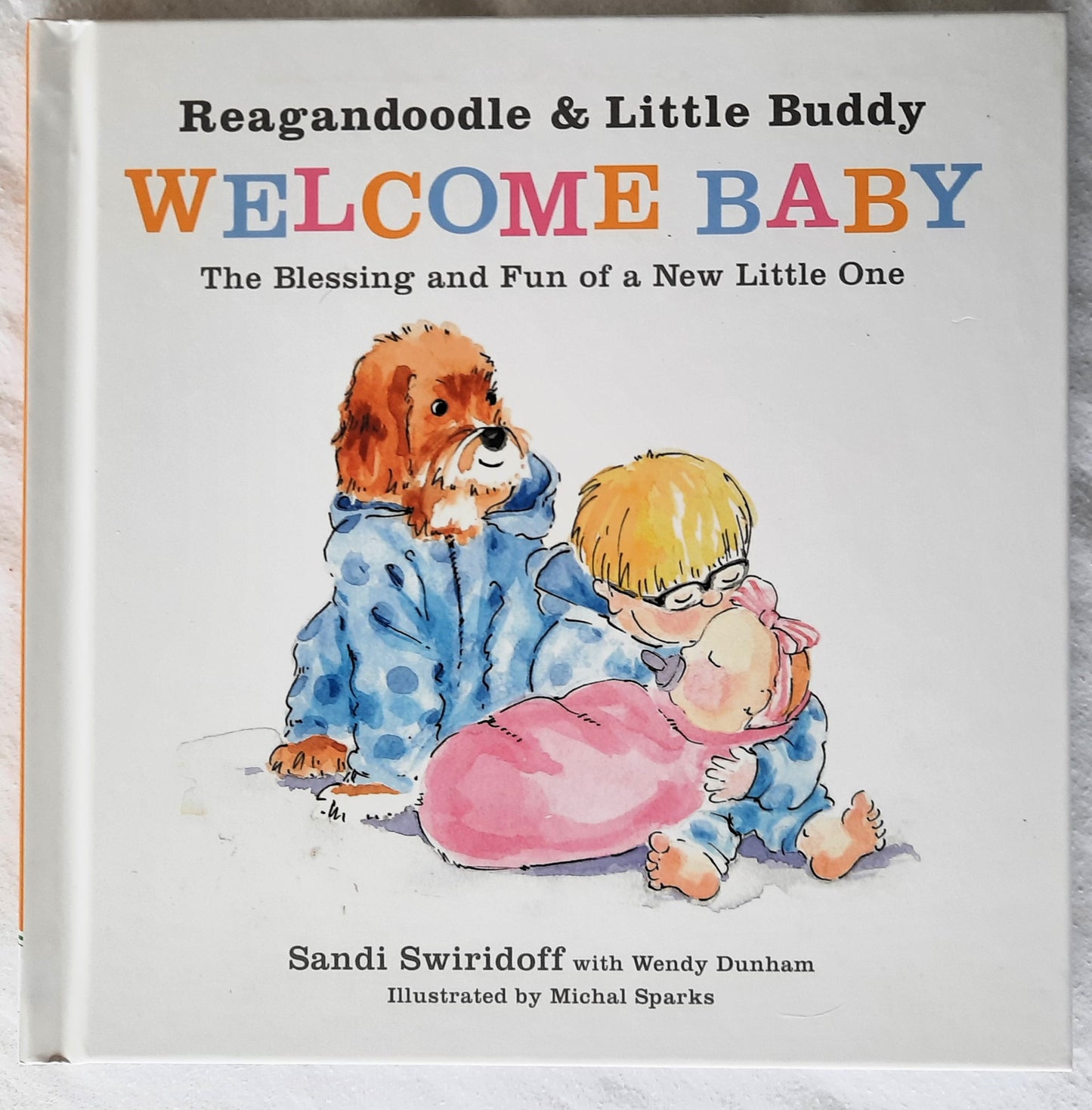 Reagandoodle and Little Buddy Welcome Baby by Sandi Swiridoff (New, 2019, HC, 48 pages, Harvest House)